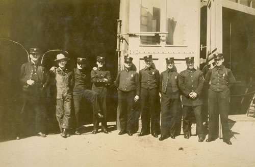 1912 - Engine Co. #4, Water Tower #1, Chemical Co. #1 men standing in front of firehouse